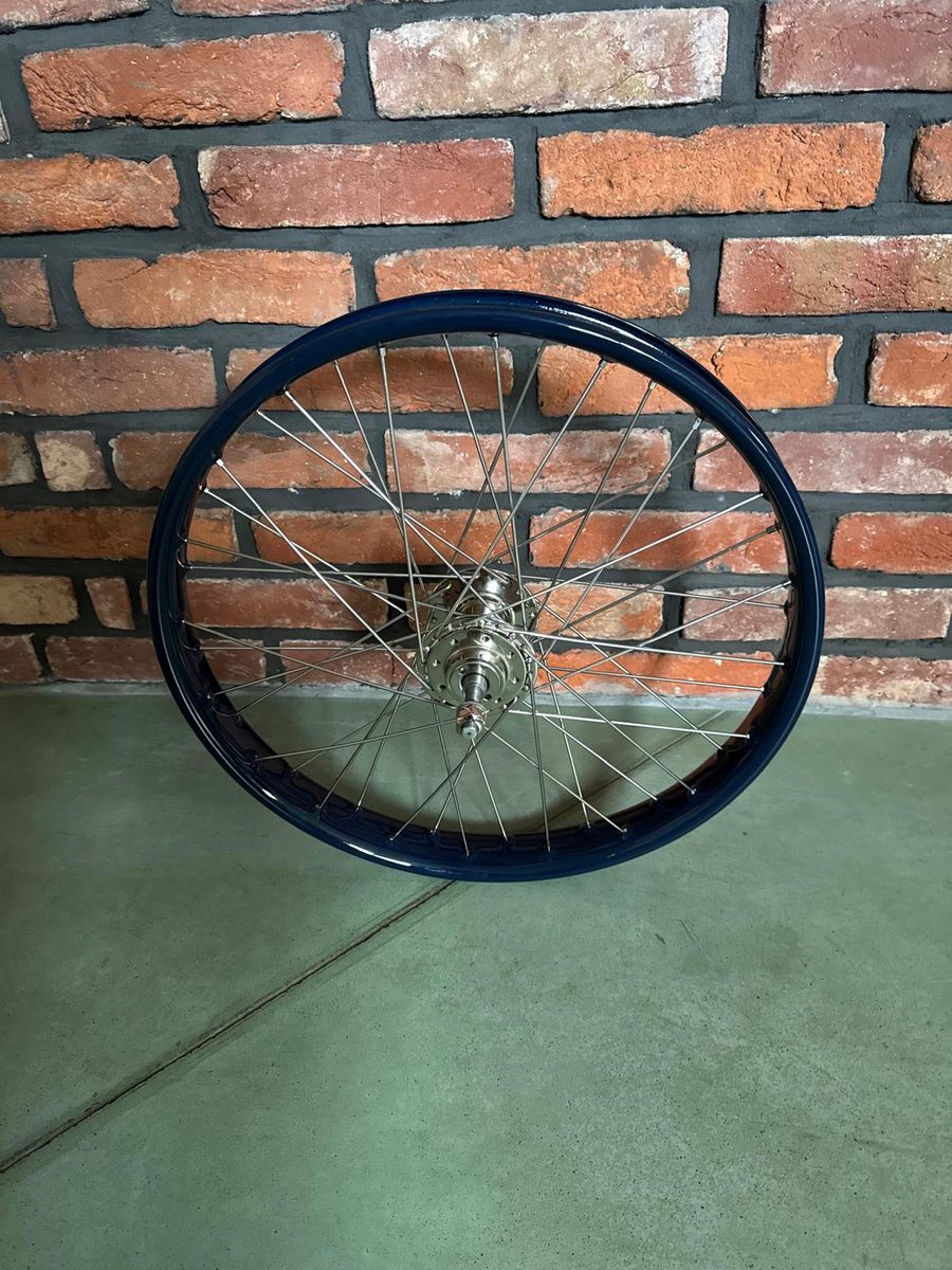 Grizzly vintage motorcycle wheel with a dark blue rim and a polished hub