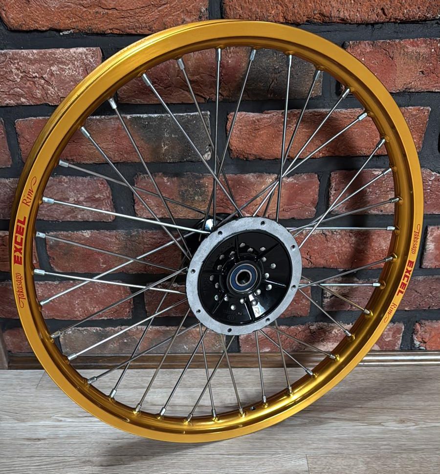 Yamaha XT 350 wheel with a gold Excel rim and a black hub